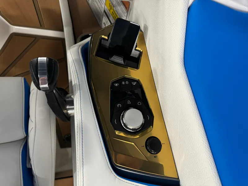Slide: The Image of Control panel of 2025 Nautique Super Air Nautique G25 Paragon with gold accents. - 13