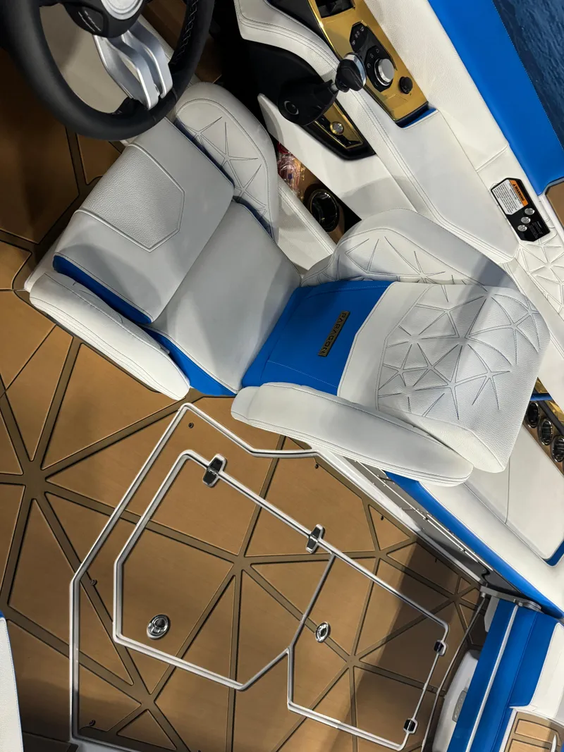 Slide: The Image of 2025 Nautique Super Air Nautique G25 Paragon interior with white and blue seating. - 14