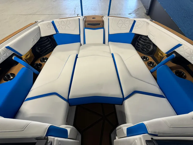 Slide: The Image of 2025 Nautique Super Air Nautique G25 Paragon interior with white and blue seating. - 18
