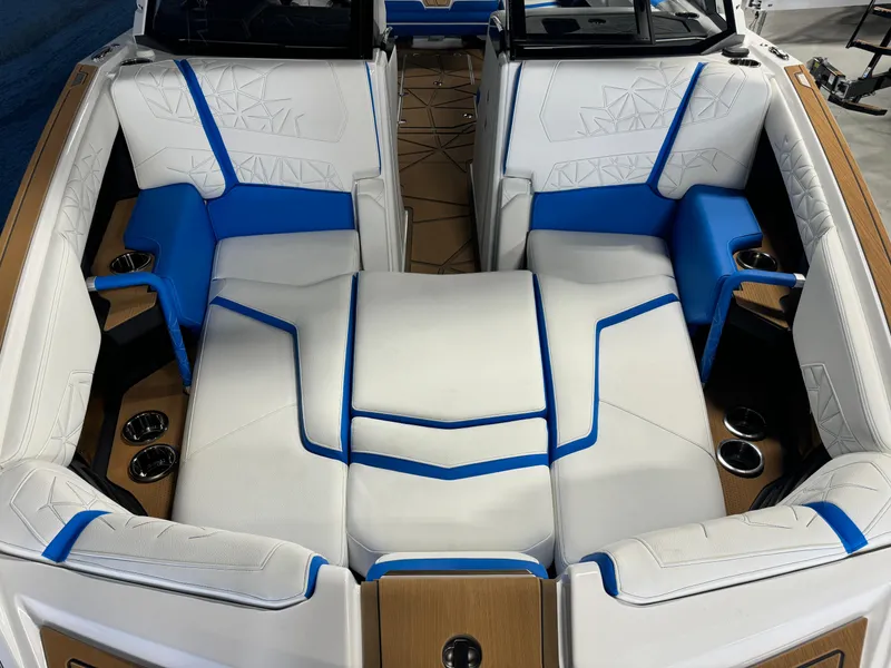 Slide: The Image of 2025 Nautique Super Air Nautique G25 Paragon interior with white and blue seating. - 19