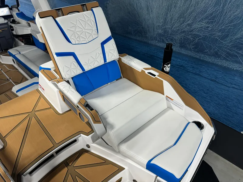 Slide: The Image of 2025 Nautique Super Air Nautique G25 Paragon boat interior with white and blue seating. - 5