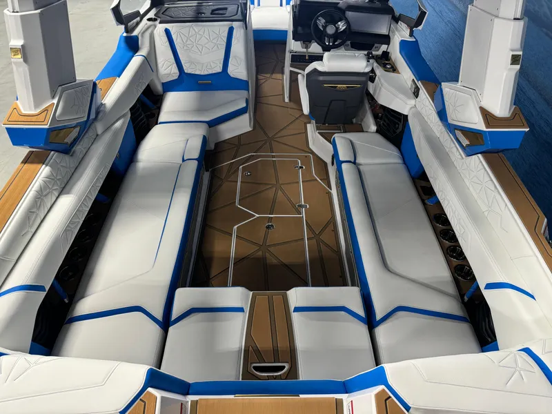 Slide: The Image of 2025 Nautique Super Air Nautique G25 Paragon interior with white and blue seating. - 7