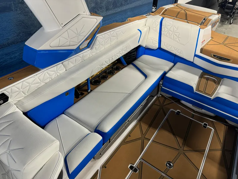 Slide: The Image of 2025 Nautique Super Air Nautique G25 Paragon interior with blue and white seating. - 8