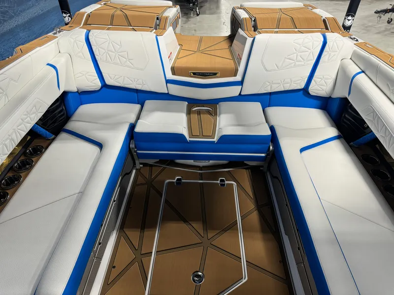 Slide: The Image of Luxurious interior of 2025 Nautique Super Air Nautique G25 Paragon boat with blue and white seating. - 9