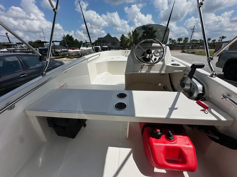 Slide: The Image of 2024 Boston Whaler 130 Super Sport boat interior with steering console and seating. - 6