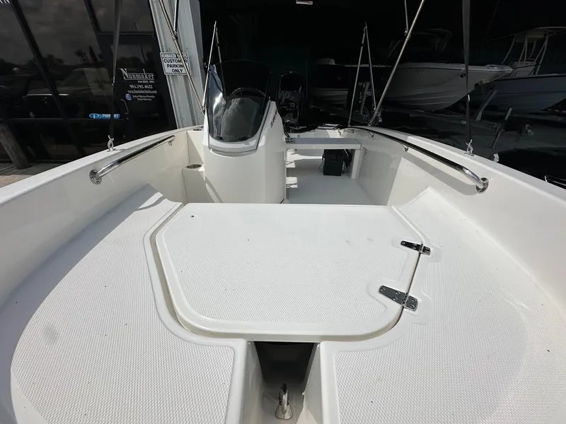 Slide: The Image of 2024 Boston Whaler 130 Super Sport boat interior, featuring a spacious deck and sleek design. - 9