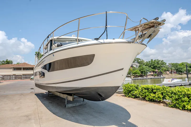 Slide: The Image of 2021 Jeanneau NC Weekender 1095 boat on dry dock, side view. - 10