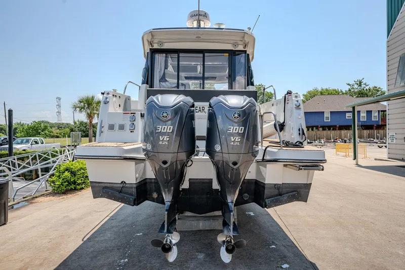 Slide: The Image of 2021 Jeanneau NC Weekender 1095 with twin 300 HP outboard engines. - 12