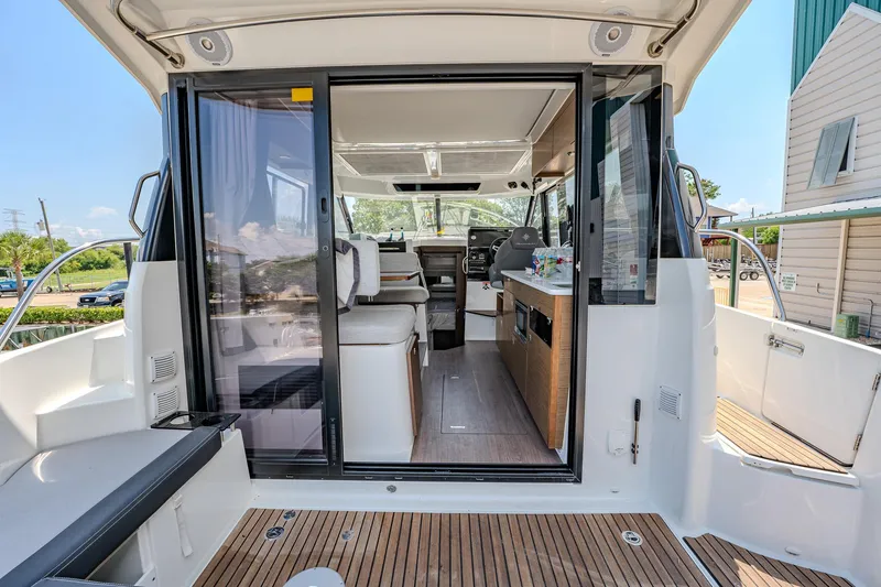 Slide: The Image of 2021 Jeanneau NC Weekender 1095 interior view with open sliding door. - 19