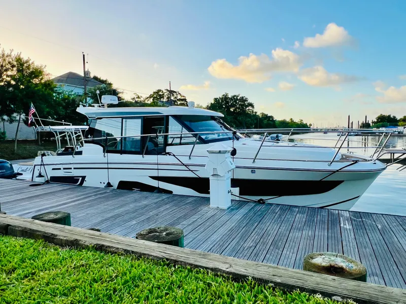 Slide: The Image of 2021 Jeanneau NC Weekender 1095 docked at a marina. - 2