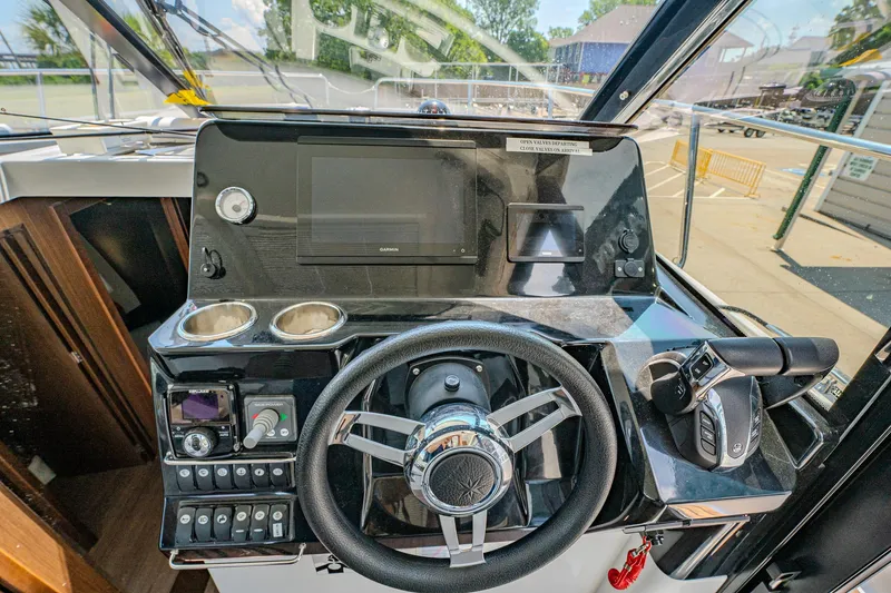 Slide: The Image of 2021 Jeanneau NC Weekender 1095 helm with steering wheel and control panel. - 23