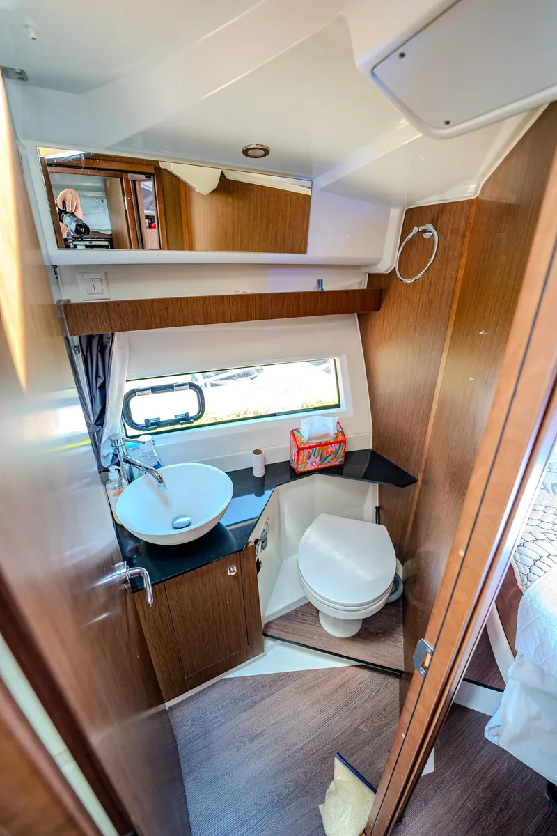 Slide: The Image of 2021 Jeanneau NC Weekender 1095 bathroom with sink, toilet, and window. - 24