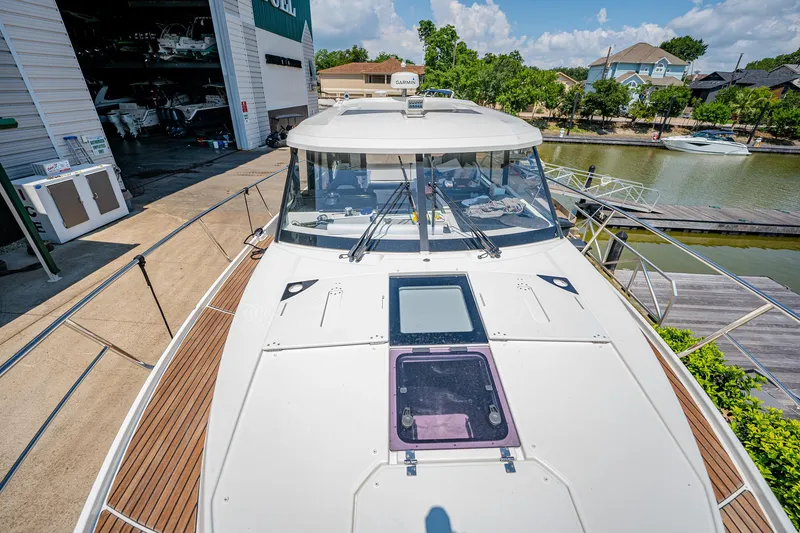 Slide: The Image of 2021 Jeanneau NC Weekender 1095 docked, showcasing spacious deck and sleek design. - 26