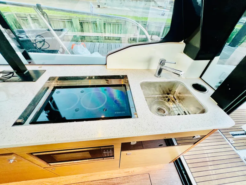 Slide: The Image of Modern kitchen area in 2021 Jeanneau NC Weekender 1095 boat. - 27