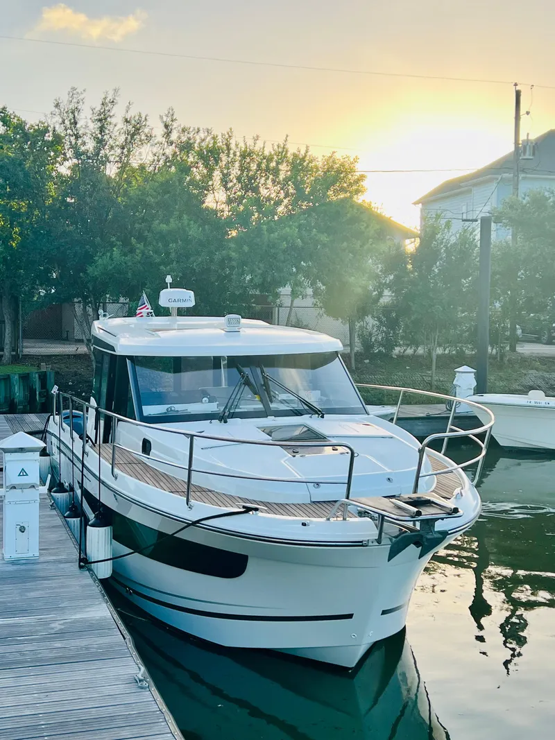 Slide: The Image of 2021 Jeanneau NC Weekender 1095 docked at sunset. - 3