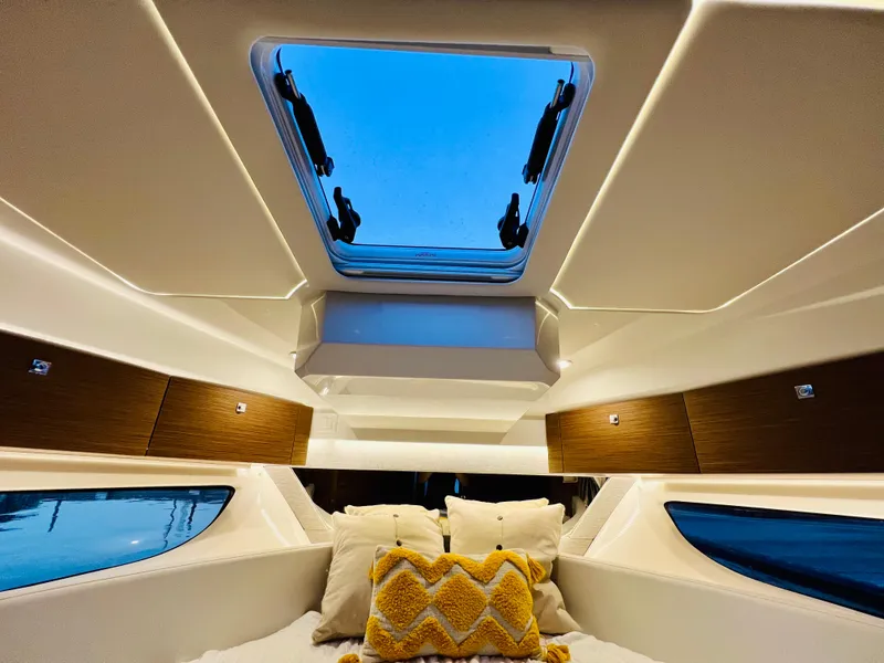 Slide: The Image of Interior cabin of 2021 Jeanneau NC Weekender 1095 with skylight and cozy bedding. - 30