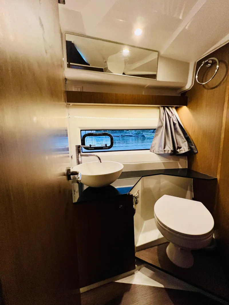 Slide: The Image of Modern bathroom in 2021 Jeanneau NC Weekender 1095 boat with sink and toilet. - 32