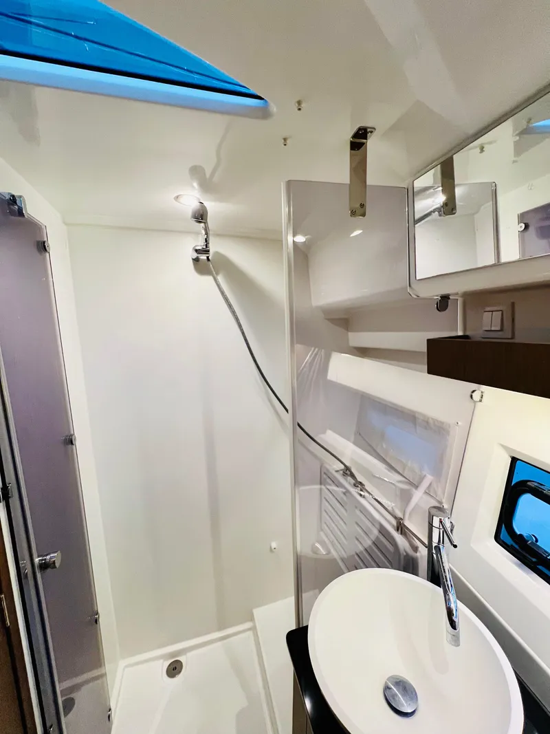 Slide: The Image of 2021 Jeanneau NC Weekender 1095 bathroom with modern fixtures and skylight. - 33