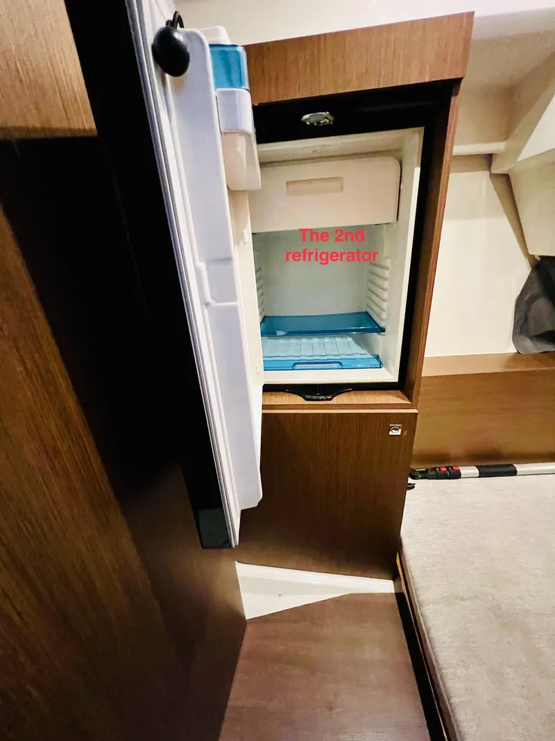 Slide: The Image of 2021 Jeanneau NC Weekender 1095 second refrigerator in cabin interior. - 35