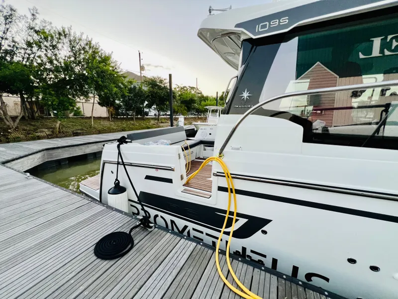 Slide: The Image of 2021 Jeanneau NC Weekender 1095 docked with yellow power cable. - 4