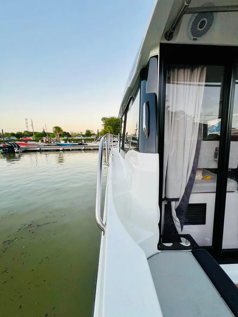 Slide: The Image of 2021 Jeanneau NC Weekender 1095 docked at a marina. - 5