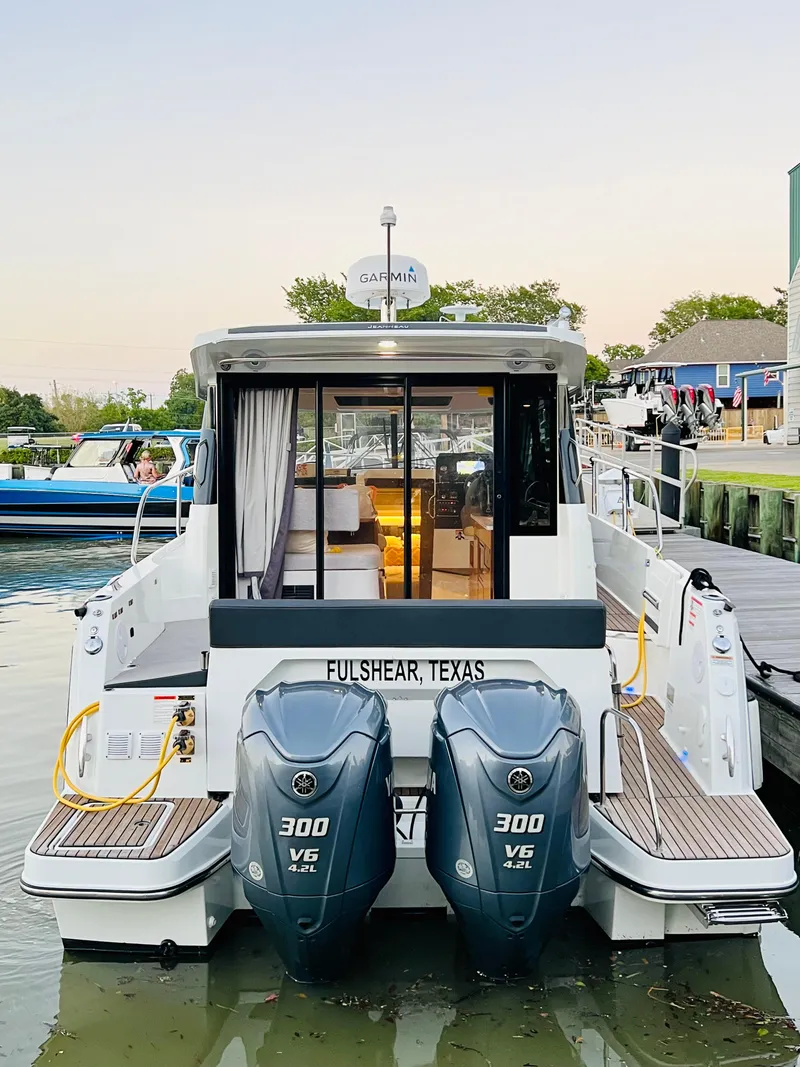 Slide: The Image of 2021 Jeanneau NC Weekender 1095 boat docked with twin Yamaha 300 engines. - 9