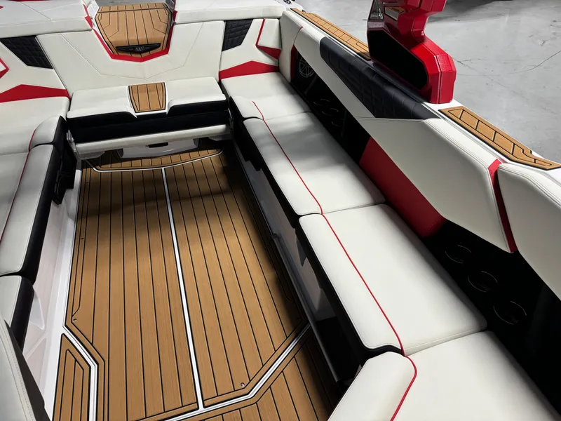 Slide: The Image of 2025 Nautique Super Air S25 interior with sleek seating and stylish wood flooring. - 10