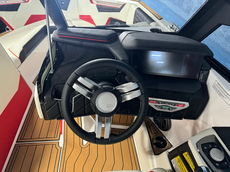 Slide: The Image of 2025 Nautique Super Air S25 boat dashboard with modern steering wheel and digital display. - 12