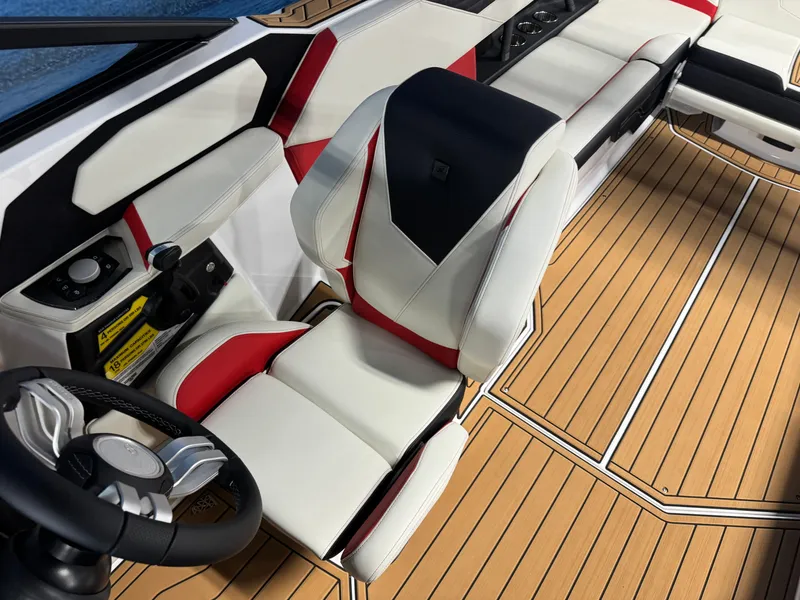 Slide: The Image of 2025 Nautique Super Air S25 interior with sleek white and red seating, modern design. - 13