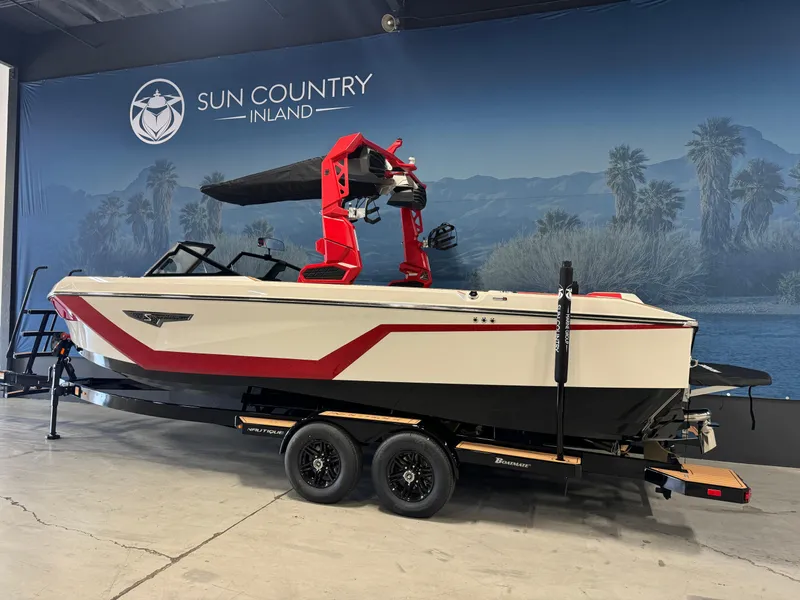 Slide: The Image of 2025 Nautique Super Air S25 boat with red accents on a trailer at Sun Country Inland. - 3