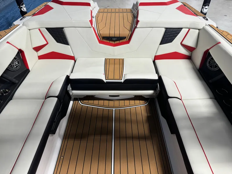 Slide: The Image of 2025 Nautique Super Air S25 interior with white and red seating, teak flooring. - 9