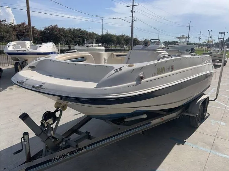 Slide: The Image of 1997 Regal 200 DESTINY boat on a trailer in a parking lot. - 2