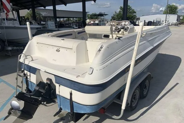 Slide: The Image of 1997 Regal 200 DESTINY boat on a trailer in a marina. - 6