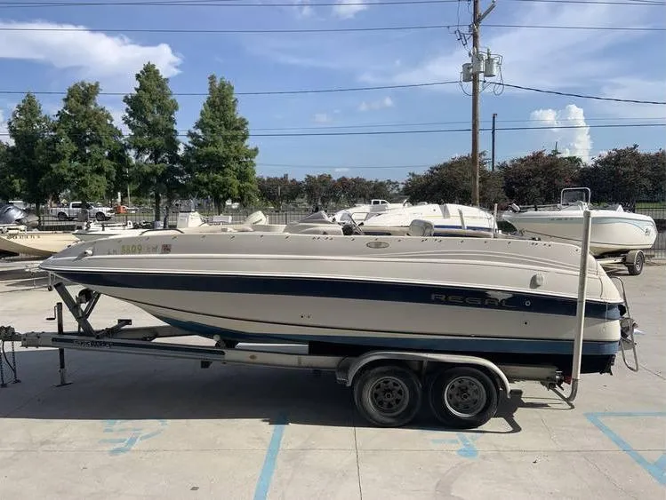 Slide: The Image of 1997 Regal 200 DESTINY boat on a trailer in a marina parking lot. - 8