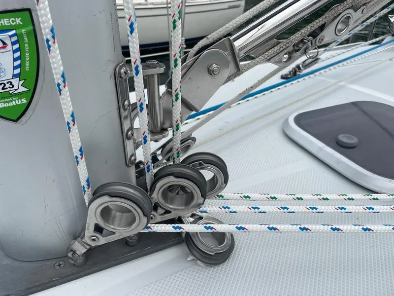 Slide: The Image of Close-up of Catalina 310 sailboat rigging and ropes, showcasing detailed deck hardware. - 10