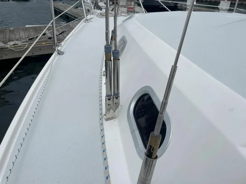 Slide: The Image of Deck view of a 2000 Catalina 310 sailboat, featuring rigging and a porthole. - 11