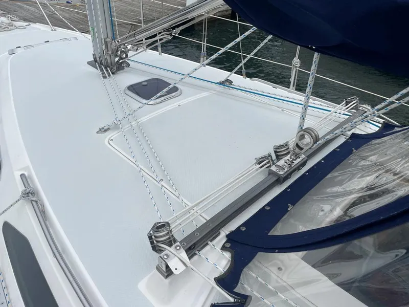 Slide: The Image of Deck view of a 2000 Catalina 310 sailboat with rigging and hatch. - 13