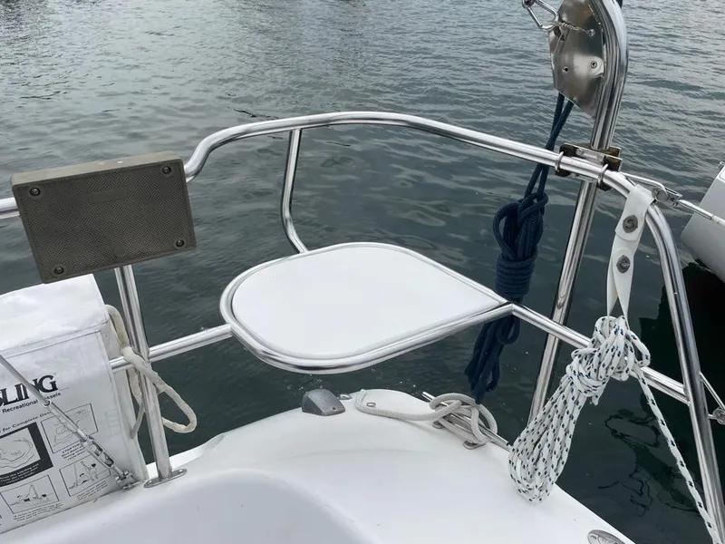 Slide: The Image of Catalina 310 sailboat stern with railing, ropes, and water view, year 2000 model. - 16