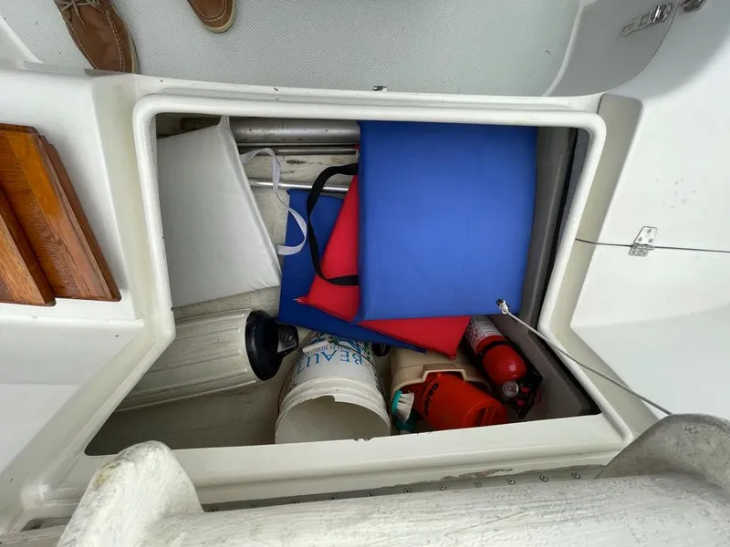Slide: The Image of Storage compartment on a 2000 Catalina 310 sailboat with safety equipment and supplies. - 17