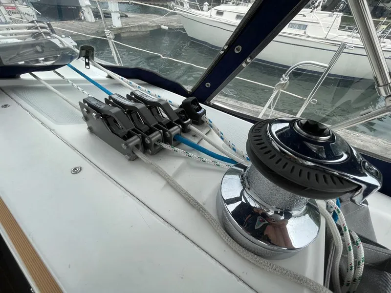 Slide: The Image of Sailing equipment on a 2000 Catalina 310 yacht, featuring winch and rope clutches. - 21