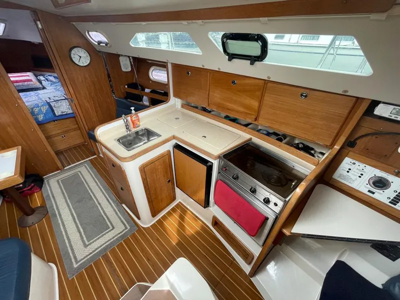 Slide: The Image of Interior of 2000 Catalina 310 sailboat with kitchen and cozy cabin layout. - 24