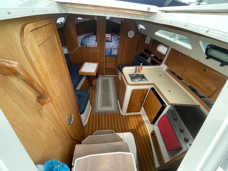 Slide: The Image of Interior of 2000 Catalina 310 sailboat with kitchen, seating, and sleeping area. - 26