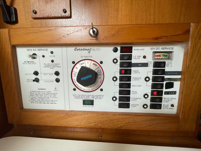 Slide: The Image of Electrical control panel of a 2000 Catalina 310 yacht with switches and dials. - 33