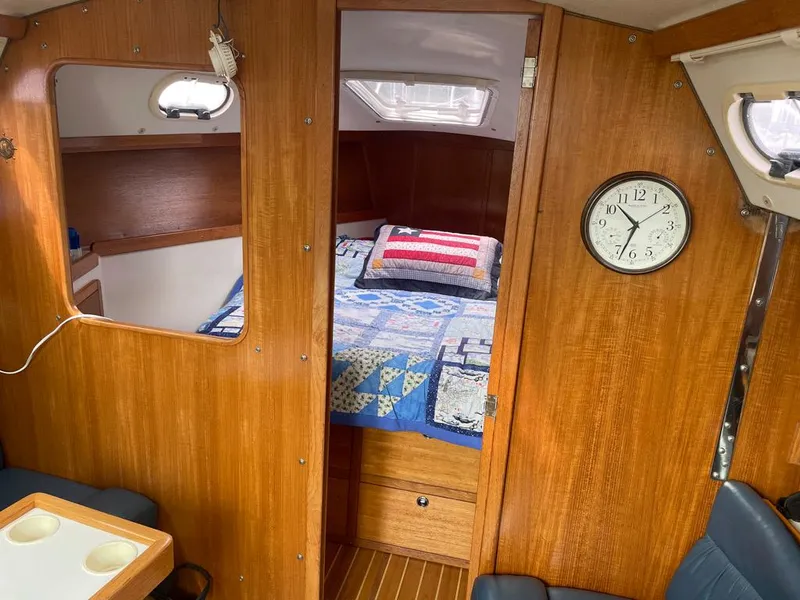Slide: The Image of Interior of 2000 Catalina 310 sailboat with cozy cabin and wooden finish. - 43