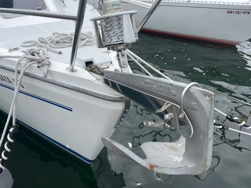 Slide: The Image of Catalina 310 sailboat anchor and bow detail, docked in calm water. - 6