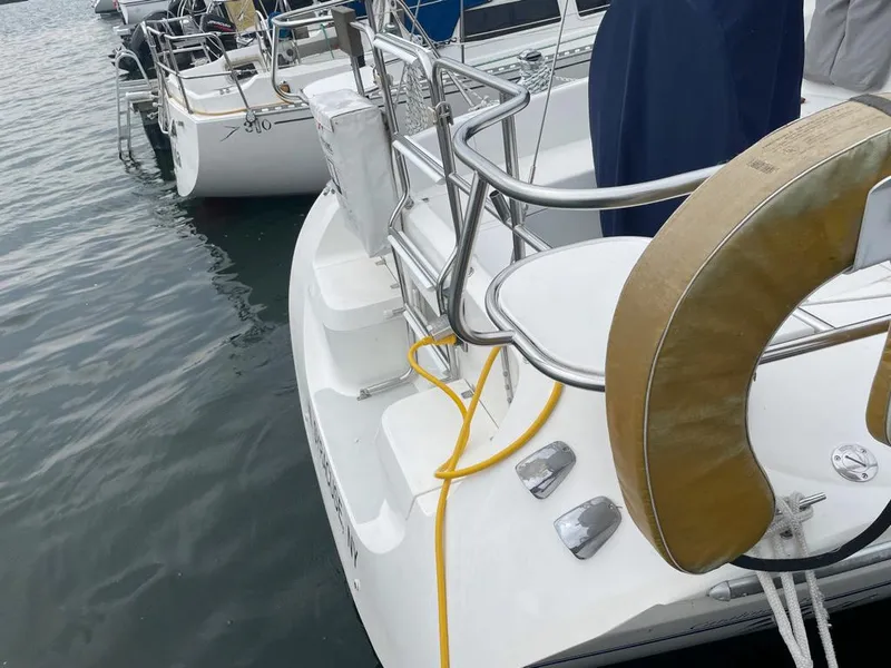 Slide: The Image of Catalina 310 sailboat, 2000 model, docked with visible life ring and yellow cable. - 7