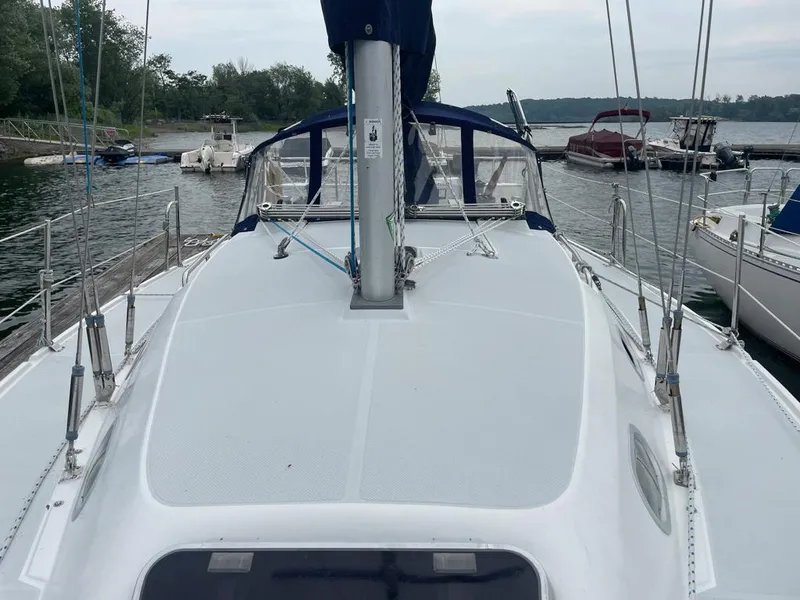 Slide: The Image of Sailboat Catalina 310, 2000 model, docked at a marina with surrounding boats. - 8