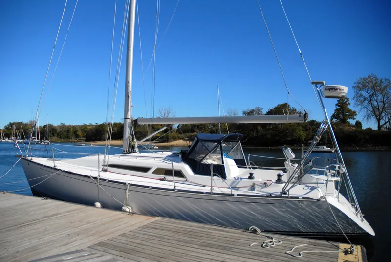 Slide: The Image of C&C 110 sailboat docked, 2001 model, clear blue sky, calm water. - 1