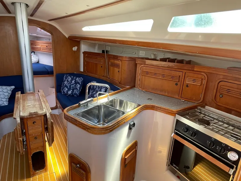 Slide: The Image of Interior of a 2001 C&C 110 sailboat with kitchen and seating area. - 13