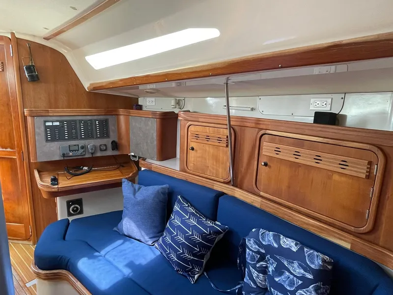 Slide: The Image of Interior of a 2001 C&C 110 sailboat with blue cushions and wooden cabinetry. - 15